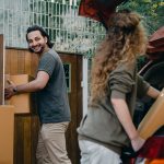 Happy couple unloading an automobile